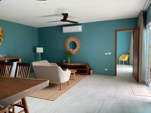 a living room with blue walls and a ceiling at Le Petit Saint Tropez in Khanom