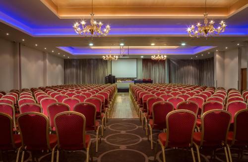 a conference room with red chairs and a screen at Loughrea Hotel & Spa in Loughrea