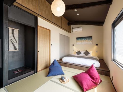 a bedroom with a bed and a large window at Sansuikyo Machiya House in Kanazawa