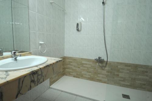 a bathroom with a sink and a shower at HOTEL MARIA ROSA in Pedrola