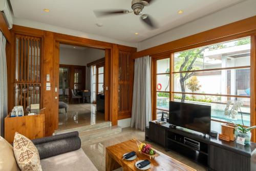 a living room with a television and a couch at The Samaya Seminyak Bali in Seminyak