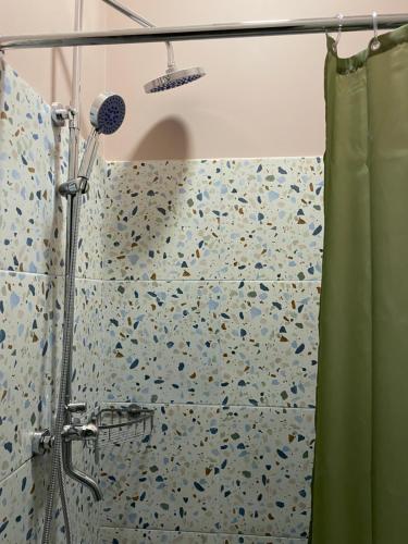 a shower with a shower curtain in a bathroom at DOMA HOSTEL in Almaty