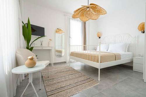 a bedroom with a bed and a table and a chair at Voger Alaçatı Köyiçi in Alacati