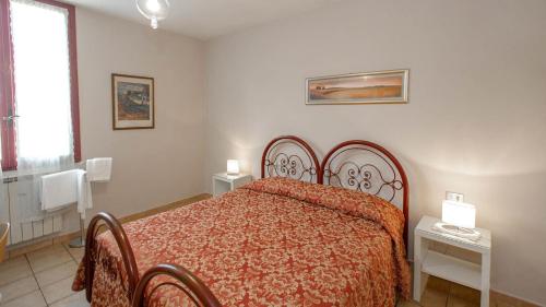 a bedroom with a bed with a red comforter at Hotel Masaccio in Florence