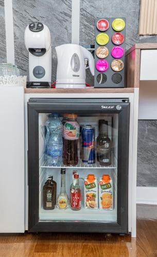 a small refrigerator filled with food and drinks at 9 Nine - Luxury Apartments & Suites in Belgrade