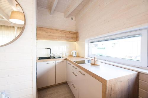 a small kitchen with a sink and a window at Łódź Wikingów in Rowy