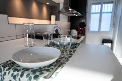 um balcão de cozinha com copos e uma tigela na mesa em Théa : Studio avec parking privé - Actif+ Location- em Marselha