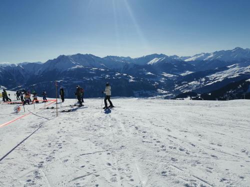 a group of people skiing on a snow covered mountain at Casa Capricorn Nähe Laax in Sagogn