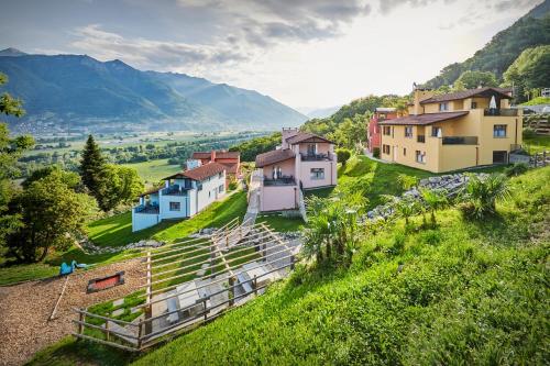 a small village on a hill with houses at Reka-Ferienanlage Magadino in Magadino