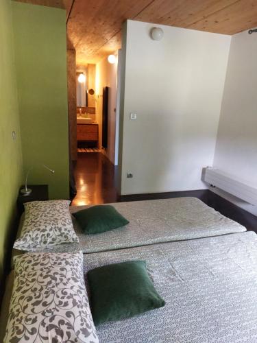 two beds in a room with green walls at Holiday Home Hisa Gusta in Most na Soči