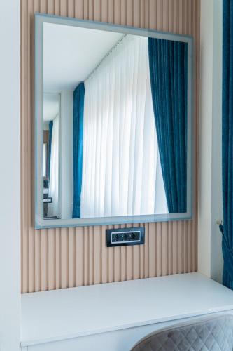 a mirror on a wall in a room at 9 Nine - Luxury Apartments & Suites in Belgrade