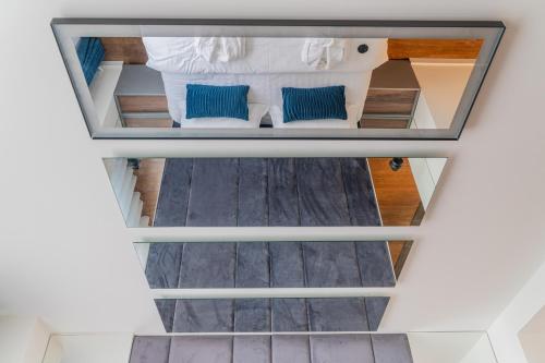 an overhead view of a bedroom with blue pillows at 9 Nine - Luxury Apartments & Suites in Belgrade