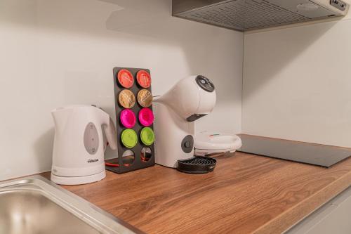 a kitchen counter with a mixer and donuts on it at 9 Nine - Luxury Apartments & Suites in Belgrade