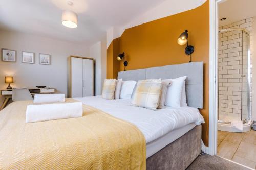 a bedroom with two beds and a yellow wall at Hidden Gem within Central Chester - Great Location in Chester