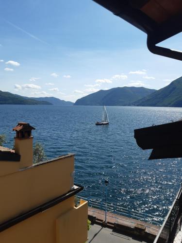 a sail boat on a large body of water at La Gabbianella - Locazione turistica in Marone