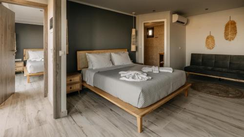 a bedroom with a large bed and a couch at Zante Calinica Hotel in Tsilivi