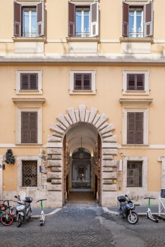 an entrance to a building with motorcycles parked outside at Glance in Rome in Rome