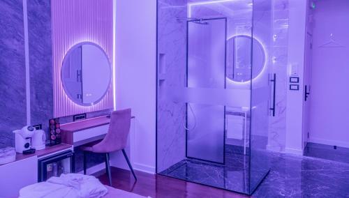 a bathroom with a shower and a sink and a mirror at 9 Nine - Luxury Apartments & Suites in Belgrade