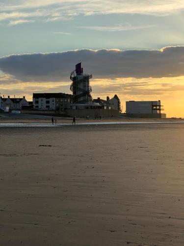 a view of a beach with a building in the background at Normanby Raybould house in Normanby