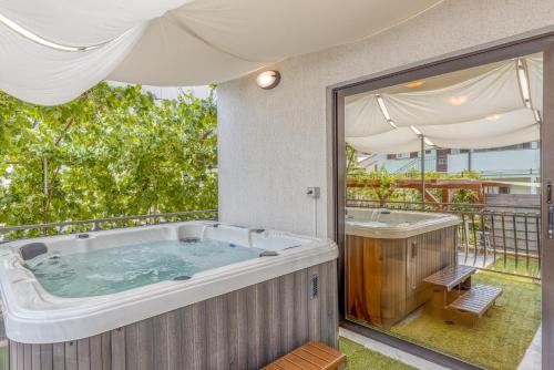 a large bath tub sitting on top of a patio at Wellness Apartment in Poreč