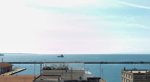 a large body of water with a pier and a boat at Sea & the City in Thessaloniki