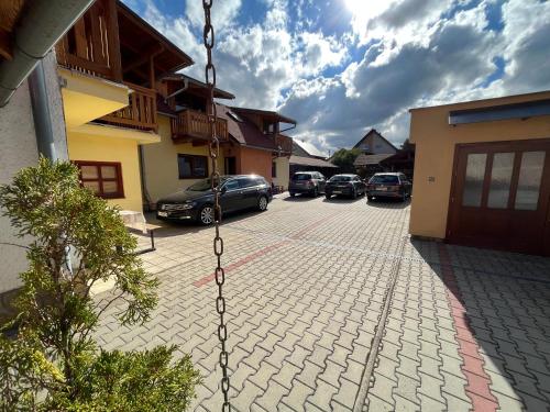 a group of cars parked in a parking lot at Penzion Siesta Grand in Hrabušice