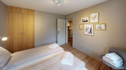 a small bedroom with a bed and a cabinet at Reka-Feriendorf Zinal in Zinal
