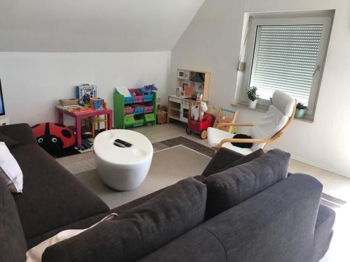 a living room with a couch and a table at Familienfreundliche Wohnung in Wewer in Paderborn