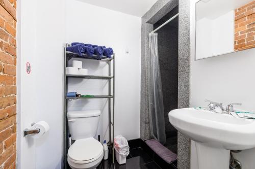 a bathroom with a toilet and a sink at Studios in New York in New York