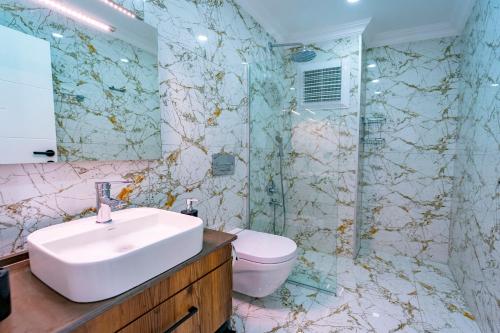 a bathroom with a sink and a toilet at Villa Destan Patara in Gelemiş
