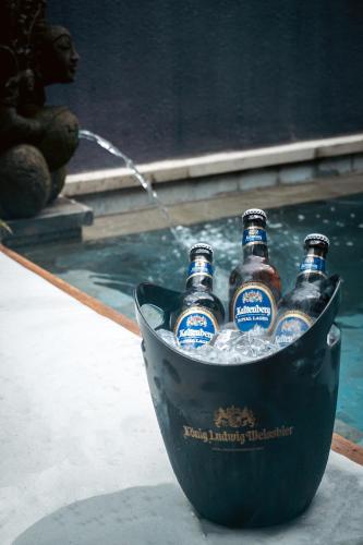 a bucket of beer bottles sitting in the water at Sampatti Villas in Seminyak