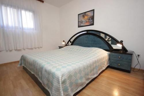 a bedroom with a bed and a dresser and a window at Apartments with a parking space Seget Vranjica, Trogir - 8623 in Seget Vranjica