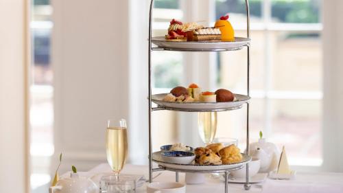 a three tiered display of food on a table at InterContinental Sanctuary Cove Resort by IHG in Gold Coast