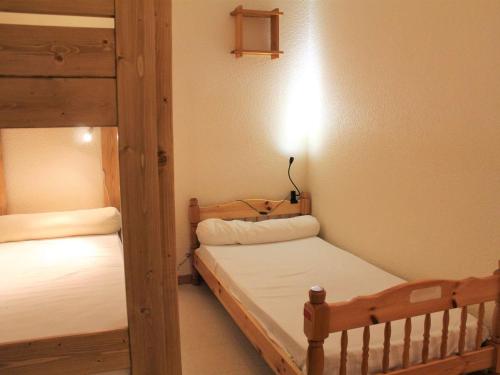 a bedroom with two bunk beds and a lamp at Appartement Vars, 1 pièce, 6 personnes - FR-1-330B-138 in Vars