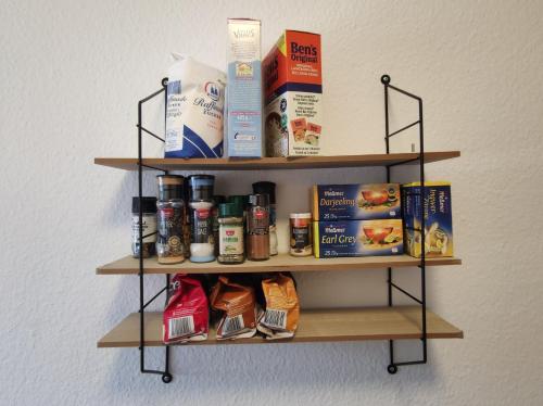 a wall mounted shelf with products on it at RheinNeckar Living - Neuhofen - Free WiFi and Parking in Neuhofen