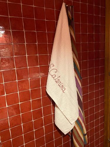 a towel hanging on a wall in a bathroom at B&B Santa Caterina in Acquaviva Picena