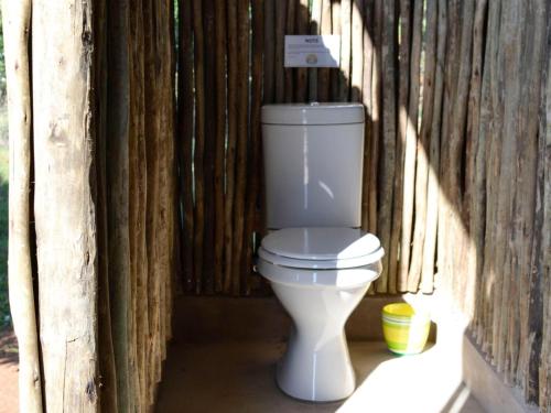 a toilet sitting inside of a wooden structure at Hluhluwe Bush Camp Glamping Village in Hluhluwe