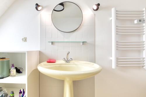 a bathroom with a sink and a mirror at L'Odyssée in Saint-Nic