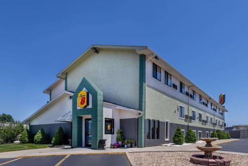a building with a fast food restaurant at Super 8 by Wyndham Kansas City at Barry Road/Airport in Kansas City