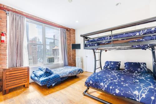 a bedroom with a bunk bed and a chair at Studios in New York in New York