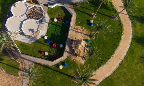 an overhead view of a park with palm trees at Safir Dahab Resort in Dahab