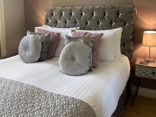 a bed with pillows on top of it at Kingfisher Lodge, South View Lodges, Exeter in Exeter