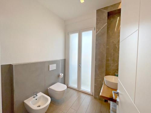 a bathroom with a toilet and a sink at Arcioun Suite in Riccione