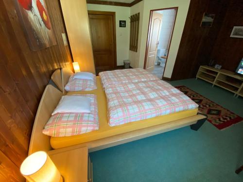 a small bedroom with two beds and a lamp at Haus Fiegl in Oetz