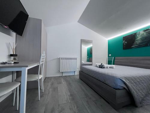 een slaapkamer met een bed, een bureau en een tafel bij VILLA FENIX OSIO SOTTO 2 in Osio Sotto