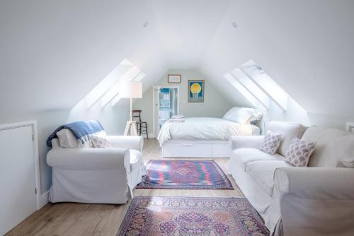 a living room with white furniture and a attic at Poplar Farm Cartlodge Earl Soham Air Manage Suffolk in Woodbridge
