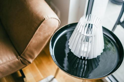a pair of white forks in a green bowl next to a chair at Love Suite in Mörbisch am See