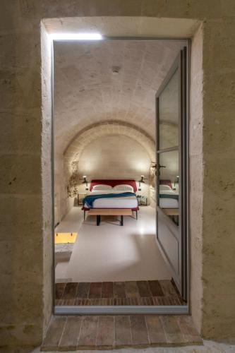 a mirror in a room with a bed in a tunnel at PIANELLE RESORT in Matera