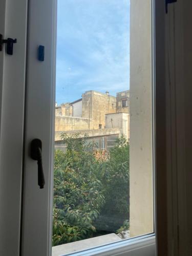 a window with a view of a building at PALAZZO PORCARI in Lecce