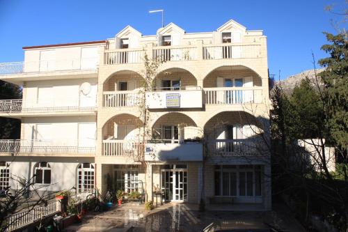 a large white building with balconies on it at Apartments by the sea Kastel Kambelovac, Kastela - 8627 in Kaštela